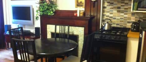 dining table, stove, fireplace, chairs