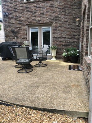PRIVATE PATIO WITH SEATING AND GAS GRILL