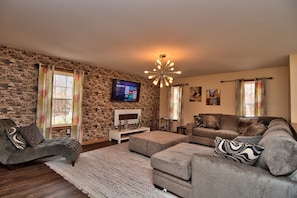Living room, featuring 55 inch LCD + premium cable, fireplace, soft couches