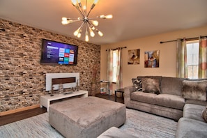 Closeup of living room with electric fireplace, smart sony TV with cable