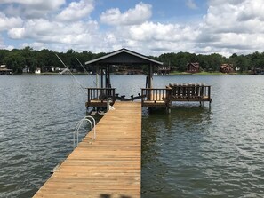Boathouse and dock equipped with ladder and stairs to access the water