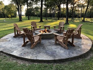 Flagstone fire pit with Adirondack chairs to enjoy s’mores or a glass of wine!