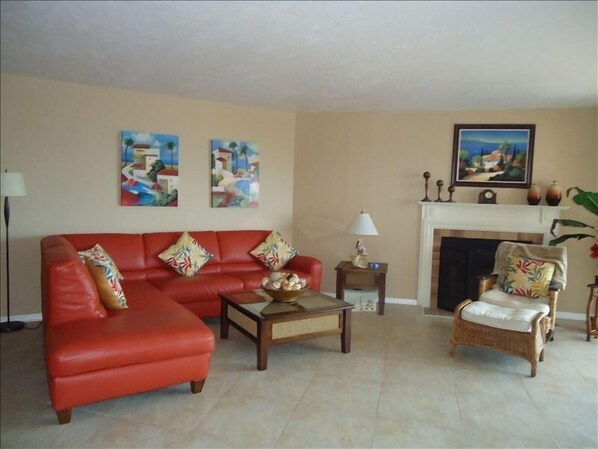 Living room w/ wood burning fireplace, 52" TV, opens to balcony and dining area.