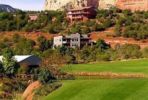 front of home (grey home) above golf course