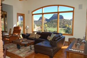 living room with large TV overlooking golf course