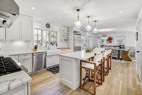 Welcoming luxury kitchen with professional appliances and Sonos