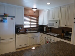 Kitchen with all new appliances, granite counters, and Keurig coffee maker. 