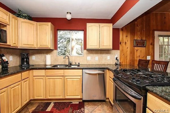 newly remodeled kitchen with granite countertop and stainless appliances