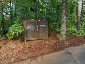 Bear proof trash bin is conveniently located next to the driveway
