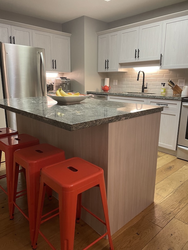 Kitchen island with granite counter and seating for 4