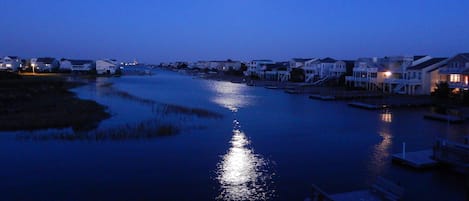 View from porch of moon rising over the bay  