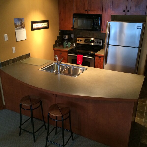 Kitchen with all appliances, dishes, pots and pans
