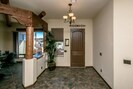 Entry with multi desk office & futon to the left.

