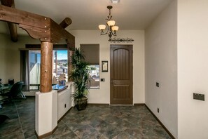 Entry with multi desk office & futon to the left.
