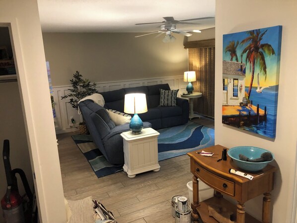 View of living area from entry way and stairs