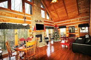 Living Room showing new hardwood floors and full stacked rock fireplace.
