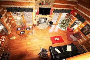 View of Living Room from upstairs showing new hardwood floors and fireplace.