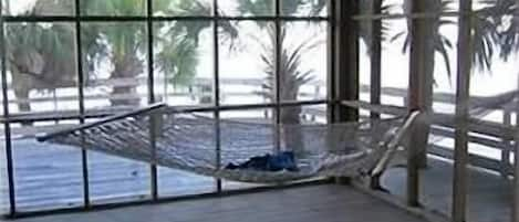 View from inside screened porch, looking east toward deck and the Gulf