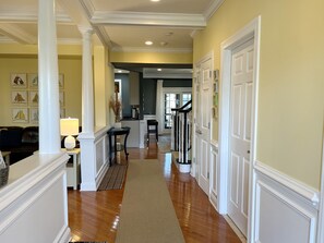 Welcome! Entrance hall with family room on left, kitchen and dining room ahead.