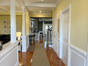 Welcome! Entrance hall with family room on left, kitchen and dining room ahead.