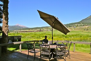 Back porch over looking the Gallatin River, Lone Peak Mountain & Golf course. 