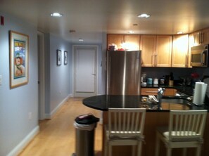 view of the kitchen and entryway from living area