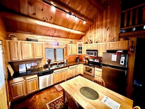 Modern fully equipped kitchen with granite countertops.