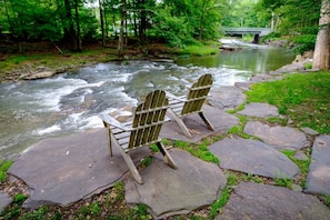 Adairondack Chairs on Stone Patio Stream Side 