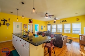 Open kitchen/living area with bar seating.
