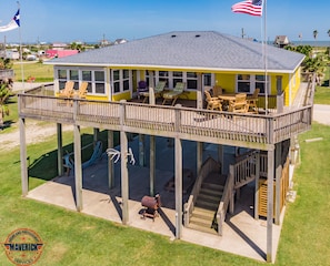 Large covered area with picnic table, smoker/grill, and outdoor shower.
