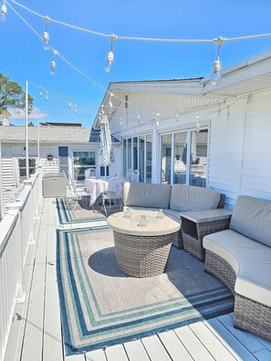 Beautiful deck has comfortable furniture, fire pit and deck lights for nighttime