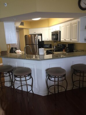 Four bar stools for extra seating in dining room