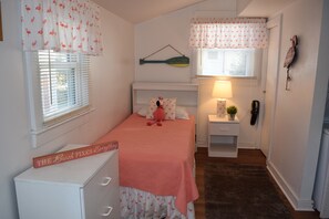 Brand New Flooring! Primary Bedroom w/Twin Bed.  Includes a private rear entrance and three-piece en-suite bathroom.