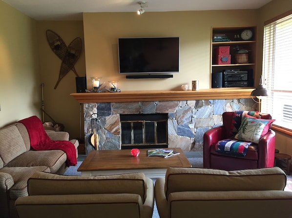 Living room with wood fireplace.