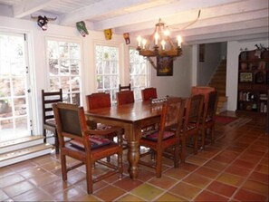 Sun-dappled dining room is set off from the living area by an antique column