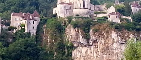 St Cirq from across Lot River - house is on the cliff, to right of the chuch