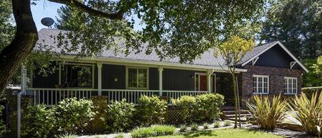 Front of property with outdoor deck & front porch swing.