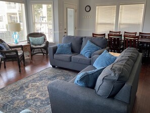View of living room with dining area behind.