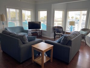 The living room becomes a sunroom when blinds are open.  View ocean and lake.