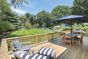 Outdoor deck with table for 8, seating area and Weber Genesis grill