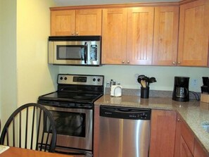 Kitchen with hardwood floors, granite counter-tops & stainless steel appliances