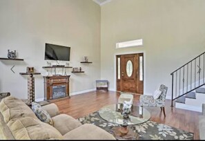 living room with electric fireplace and flat screen smart tv