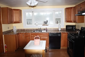 Full Kitchen with a beautiful view overlooking the Thunder Bay River & the Mill