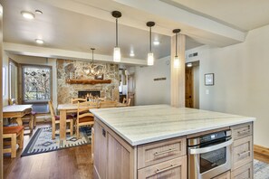 Kitchen island with view to dining room and fireplace