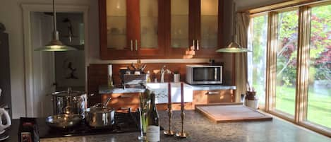 Our well equipped sun filled kitchen with granite island/oven is a delight! 