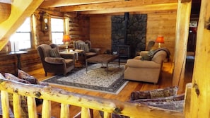 Main level living room with wood burning stove.