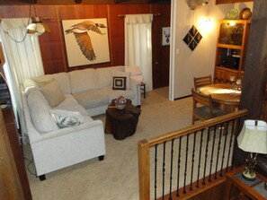Comfortable living room with sectional, game table,  60" Smart TV