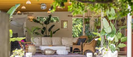 Large covered deck with comfy lounging space.