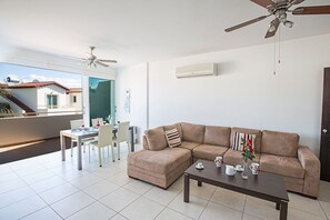 Living room with comfortable corner sofa and dining area