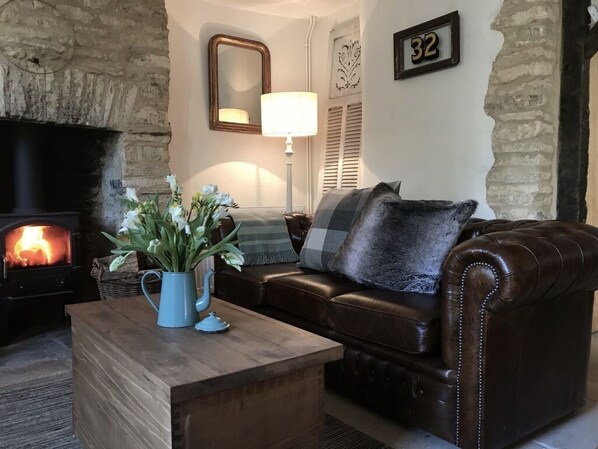 Cosy-up by the wood burner on the leather sofas